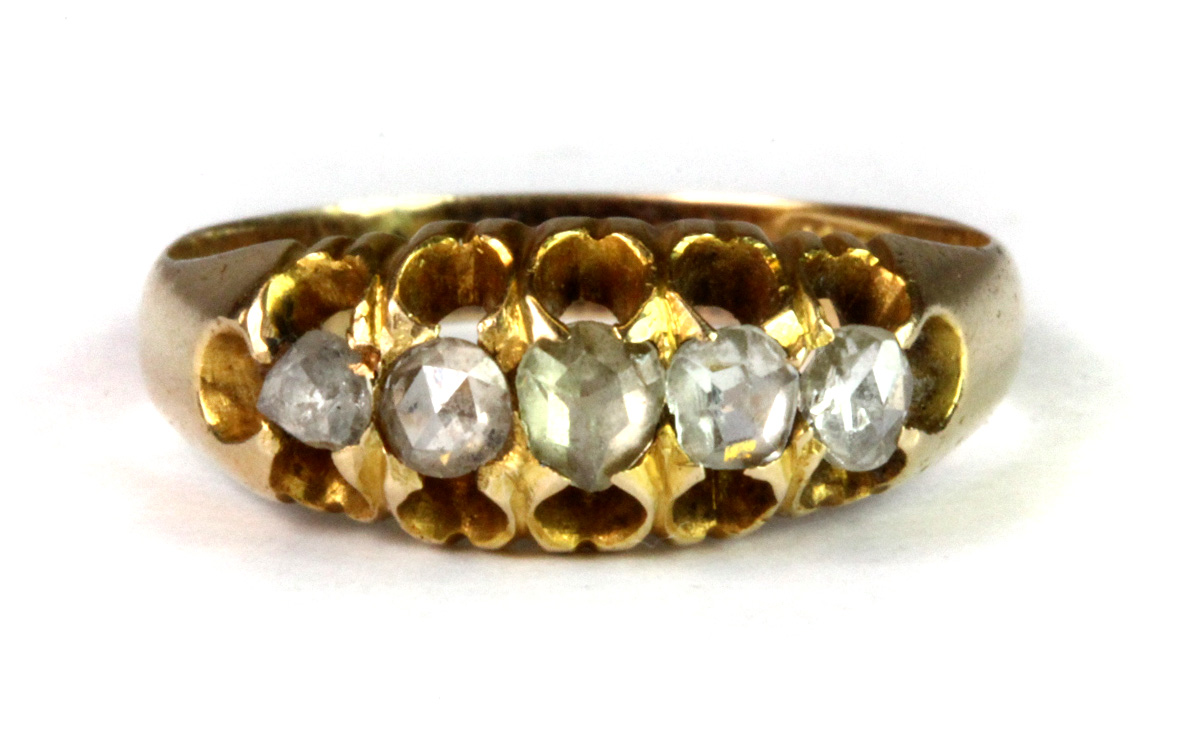 A Victorian 15ct yellow gold (stamped 625) ring set with three old cut diamonds and two