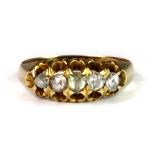 A Victorian 15ct yellow gold (stamped 625) ring set with three old cut diamonds and two