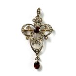 An Edwardian 9ct yellow gold (stamped 9ct) brooch / pendant set with seed pearls and garnets.