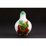 A Chinese four layer Peking glass snuff bottle of the Happy Buddha sitting in a lotus with a faux
