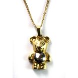 A 9ct yellow and white gold bear pendant and chain.