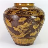 An 18th century Chinese two colour glazed terracotta jar decorated with dragons, H. 27cm.