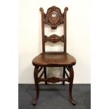 A 19th century mahogany carved hall chair.