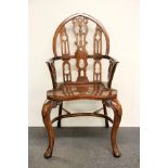 A mahogany Windsor armchair; with Gothic arched and pierced splat back, solid seat and raised on