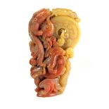 A mid 20th century Chinese carved two colour hardstone figure of dragons fighting over coins, H.
