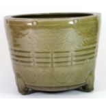 A 19th century Chinese incised celadon glazed pottery bowl, H. 16cm, Dia. 21cm.