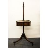 A Regency trefoil shaped walnut smokers stand, raised on tripod legs terminating in three short