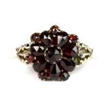 An antique yellow metal (tested 9ct yellow gold) garnet cluster ring (K), (one small garnet