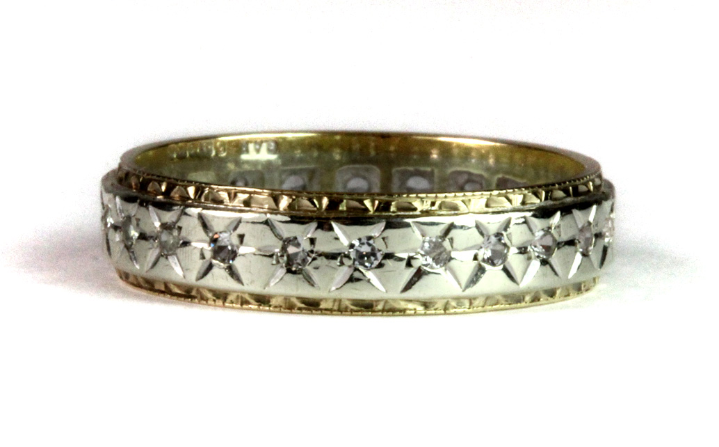 A 9ct yellow and white gold stone set full eternity ring (Q).