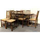 A dark oak extending dining table and eight chairs, 166 x 88cm closed.