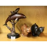 A bronze figure of a dolphin and calf on a black marble base (H. 28cm) and two bronze cat figures.