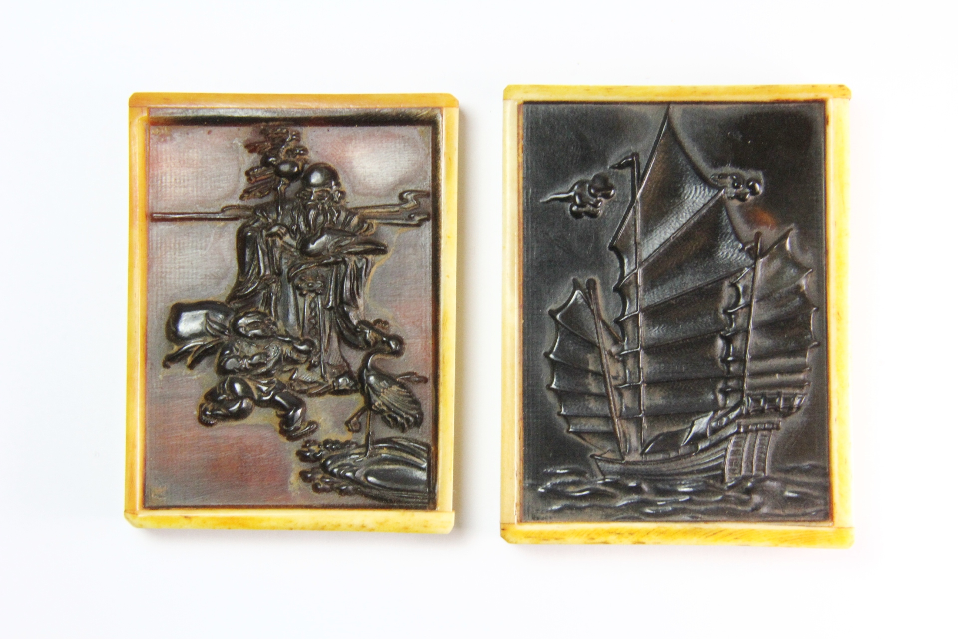 Two interesting carved horn and bone Chinese panels one depicting Shou Lao the other a sailing