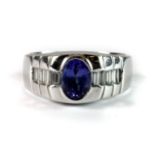 A heavy gentleman's 14ct white gold (stamped 14K) ring set with an oval cut tanzanite and diamond