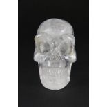 A carved rock crystal skull, H. 7cm.