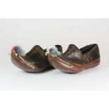 A pair of small miniature eastern leather shoes brought back from Mesopotamia in the First World