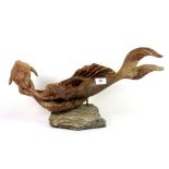 A carved hardwood and stone mermaid sculpture, W. 54cm.