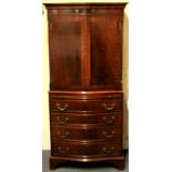 A 20th century mahogany drinks cabinet over a single drawer and three "blind drawer" cupboard, W.