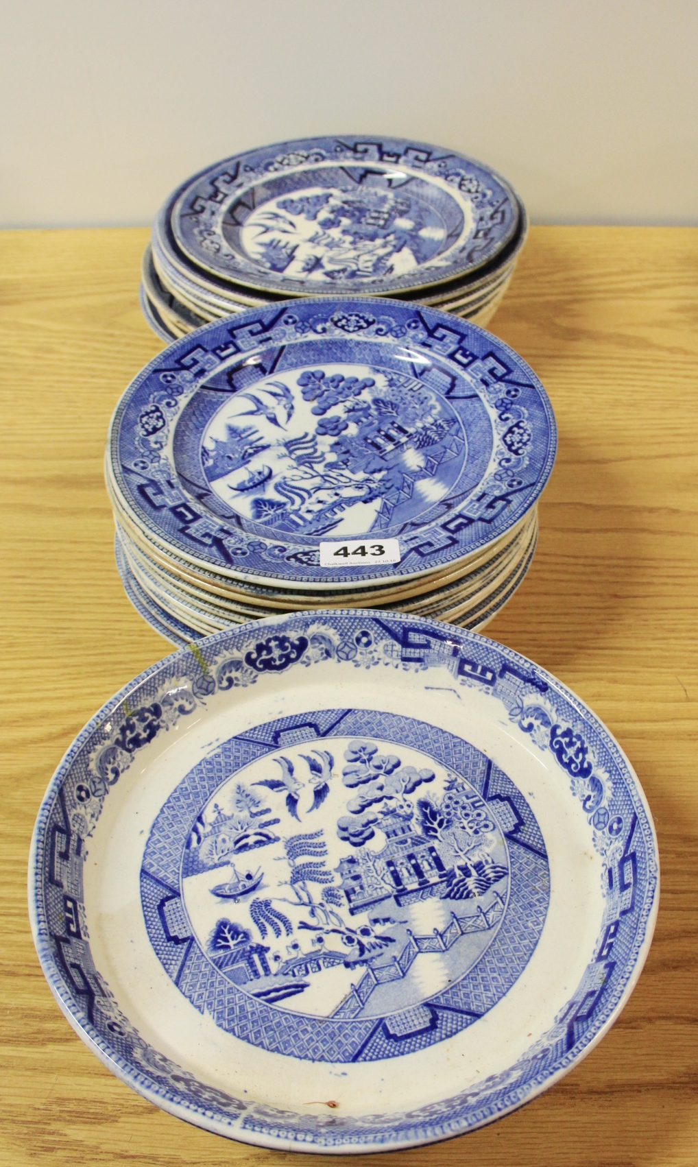 An extensive quantity of blue and white willow pattern plates.