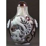 A Chinese three layer Peking cameo glass snuff bottle, H. 7.5cm.