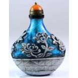 A Chinese carved two colour Peking glass snuff bottle with gilt and orange hardstone stopper, H.