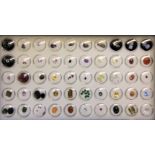 A box containing over 80 un-mounted gemstones including diamonds, natural green sapphires, rubies,