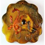 An unusual Chinese carved mixed colour water buffalo hoof amulet of a mythical dragon and
