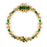 A matching 18ct yellow gold bracelet set with cabochon cut emeralds and brilliant cut diamonds (very