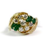 A matching 18ct yellow gold (tested) ring set with pear cut emeralds and brilliant cut diamonds (