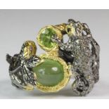 A Hana Maae designer 925 silver gilt chameleon shaped ring set with a cabochon cut prehnite,
