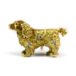 A lovely 18ct yellow gold (stamped 750) spaniel shaped brooch set with diamonds and rubies. L. 4.