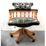 A leather upholstered swivel captain's style office chair.