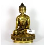 A Tibetan gilt bronze figure of the seated Buddha, H. 20cm.