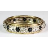 A 9ct yellow and white gold diamond and sapphire set full eternity ring (P).