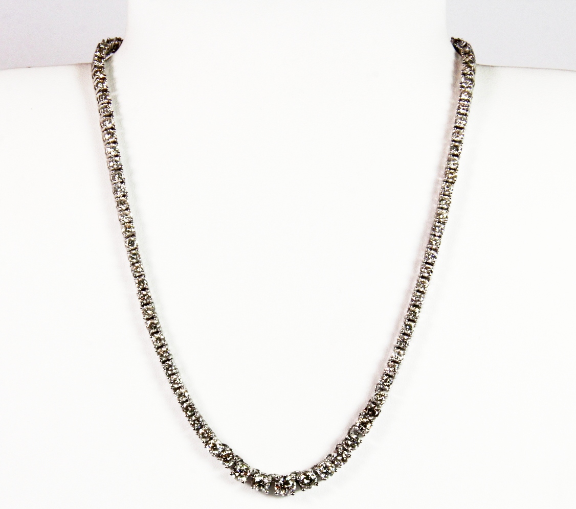 An 18ct white gold graduated diamond necklace, set with approx. 18.35ct of diamonds. Est. £7,000 -