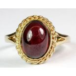 A 9ct yellow gold ring set with a cabochon cut tourmaline, (L.5).