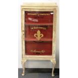 A 1930's painted glass display cabinet featuring French advertising, W. 60cm, H. 125cm.