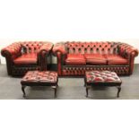 An ox blood leather upholstered three seater Chesterfield settee, armchair and two matching stools.