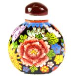 A Chinese enamelled milk glass snuff bottle with cornelian stopper, H. 6cm.