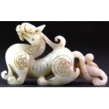 A Chinese mutton fat jade figure of a dragon. L. 10cm H. 5.5cm. Est. £150 - 200.