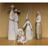 Three Lladro figures and a Nao figure of a girl with a rabbit.