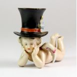 A lovely 19th century German porcelain cherub "cake" candlestick, L. 7cm, H. 5.5cm.