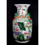 An early 20th century Chinese Canton enamelled porcelain vase decorated with scenes of the