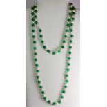 A cultured pearl and polished jade bead necklace.