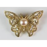 A white metal gilt butterfly brooch set with a cultured pearl and cubic zirconia, L. 4.5cm.