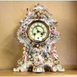 A 19th century German porcelain cased clock decorated with bocage and putti, H. 37cm.