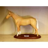 A Beswick figure of a bay horse, H. 21cm.