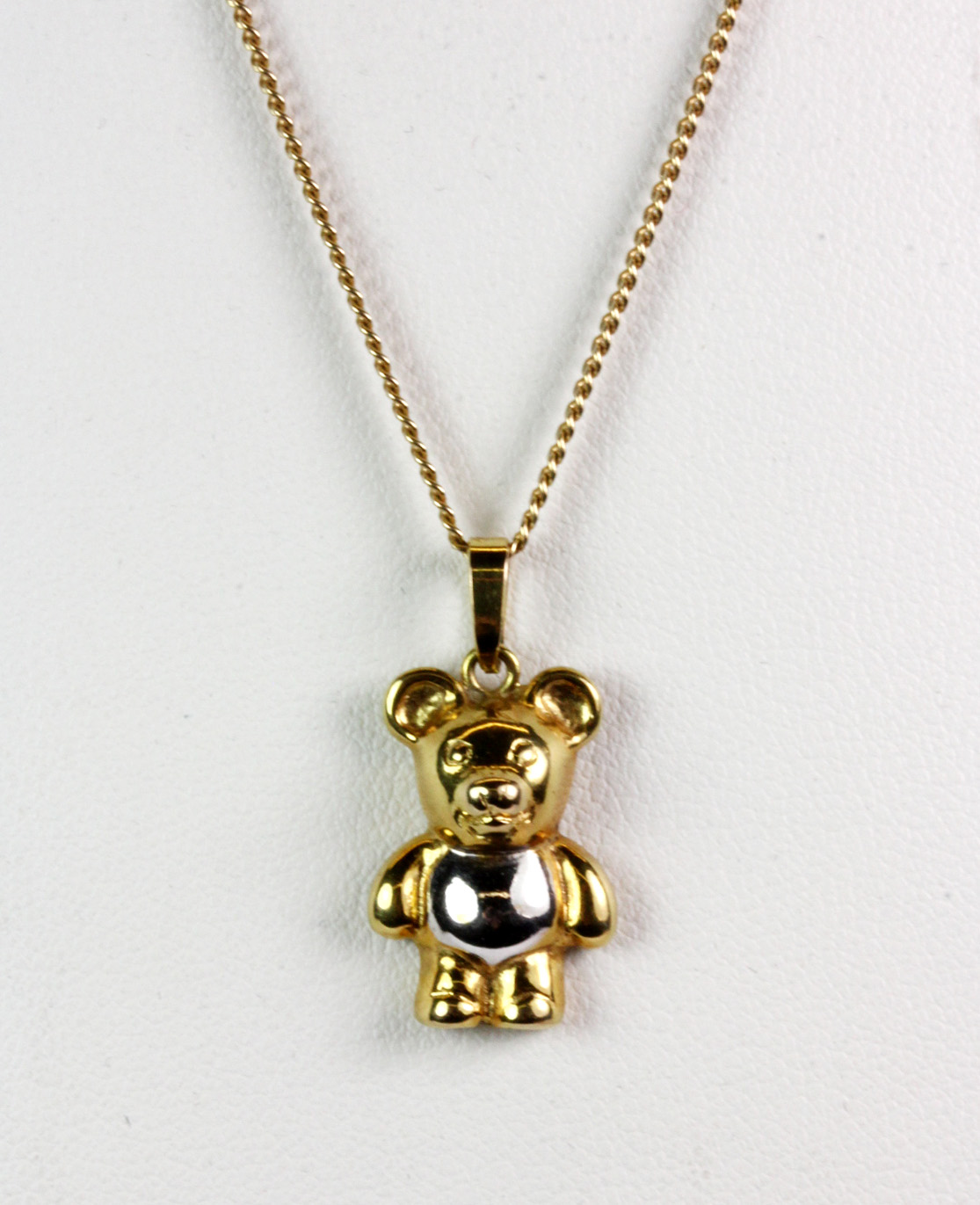 A 9ct yellow and white gold bear pendant and chain (approx. 3.7gr).