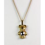 A 9ct yellow and white gold bear pendant and chain (approx. 3.7gr).