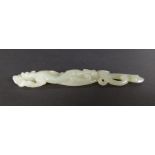 A 19th / early 20th century Chinese carved celadon jade figure of an elongated dragon, L. 12.5cm. £