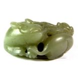 An interesting Chinese nephrite jade carving of a dragon and baby playing with a bat shaped cash,